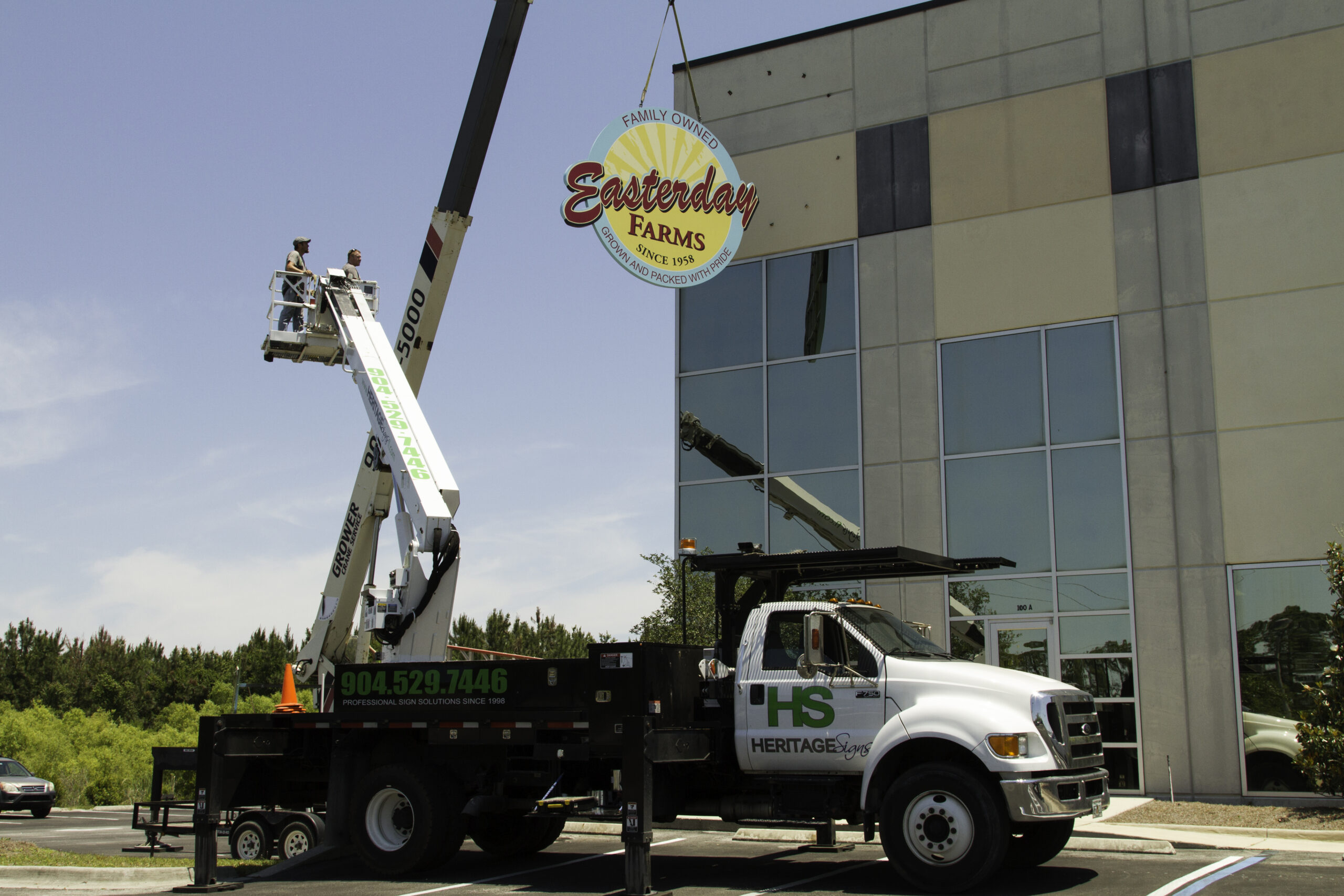 Large Sign Truck Installing Sign